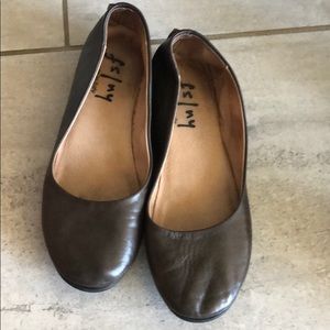 Brown leather flats.